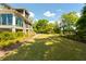 Expansive backyard offers lush green space and picturesque views of the home's exterior at 2538 Helmsman Rd, Johns Island, SC 29455