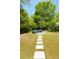 Expansive backyard with a stone walkway leading to a lounge area with ample seating at 2538 Helmsman Rd, Johns Island, SC 29455