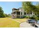 Sprawling backyard with outdoor lounge, patio, walkway, and lush landscaping at 2538 Helmsman Rd, Johns Island, SC 29455