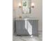 Bright bathroom featuring a gray vanity with marble countertop, and a large mirror at 2538 Helmsman Rd, Johns Island, SC 29455