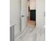 View into the bathroom featuring marble floors, a white door, and a black chest of drawers at 2538 Helmsman Rd, Johns Island, SC 29455
