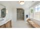 A bright bathroom featuring a walk in shower, vanity, and bench at 2538 Helmsman Rd, Johns Island, SC 29455