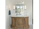 Bathroom vanity featuring a wood cabinet, white countertop and modern fixtures at 2538 Helmsman Rd, Johns Island, SC 29455
