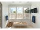 Elegant bathroom with three windows, woven shades, a TV, and a towel rack at 2538 Helmsman Rd, Johns Island, SC 29455