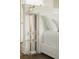 Beautiful bedroom showcasing a refined nightstand with glass shelving and decorative accents at 2538 Helmsman Rd, Johns Island, SC 29455