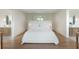 Bright bedroom showcasing light hardwood floors with a view of the double vanity baths at 2538 Helmsman Rd, Johns Island, SC 29455