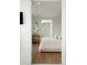 Tastefully decorated bedroom with hardwood floors, a bathroom, and neutral tones at 2538 Helmsman Rd, Johns Island, SC 29455
