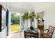 Bright dining room with a view of the lake and decorated table with a fig plant in the center at 2538 Helmsman Rd, Johns Island, SC 29455