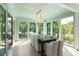 Bright dining room has dark wood table and chairs with lots of natural light and an elegant chandelier at 2538 Helmsman Rd, Johns Island, SC 29455