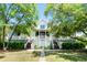 Charming home featuring double staircases leading to a covered porch and a manicured front lawn at 2538 Helmsman Rd, Johns Island, SC 29455