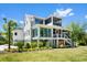 Beautiful home with expansive windows, screened porches, and a meticulously landscaped lawn at 2538 Helmsman Rd, Johns Island, SC 29455