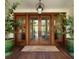 Elegant wood front door with glass panels, potted plants, and a welcoming entrance at 2538 Helmsman Rd, Johns Island, SC 29455