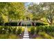 Charming front exterior featuring a grand staircase, beautifully maintained lawn, and stone walkway at 2538 Helmsman Rd, Johns Island, SC 29455