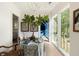 Hallway with decoratively covered table, fig plant, and view of a blue sitting room with light filled windows at 2538 Helmsman Rd, Johns Island, SC 29455