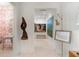 Hallway featuring art on the walls, wood sculpture, and a view to a powder room at 2538 Helmsman Rd, Johns Island, SC 29455