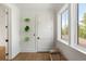 Bright hallway with hardwood floors, a decorative wall display, and a comfortable rattan bench near the window at 2538 Helmsman Rd, Johns Island, SC 29455