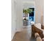 Hallway with decoratively covered table, fig plant, and view of a blue sitting room at 2538 Helmsman Rd, Johns Island, SC 29455