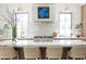 Modern kitchen with marble countertops, a sleek cooktop, and a well-lit bar seating area perfect for casual meals and gatherings at 2538 Helmsman Rd, Johns Island, SC 29455