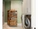 Well-organized laundry room with stylish wallpaper and wooden cabinet at 2538 Helmsman Rd, Johns Island, SC 29455