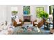 Cozy living room with fireplace, warm toned wicker chairs and decorative gold trimmed coffee table at 2538 Helmsman Rd, Johns Island, SC 29455