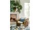 Fireplace with decor, rattan chair and glass topped coffee table in sunlit living room at 2538 Helmsman Rd, Johns Island, SC 29455