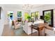 Bright living room with fireplace, light wood floors and large windows with natural light at 2538 Helmsman Rd, Johns Island, SC 29455