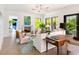 Bright living room with fireplace, light wood floors and large windows with natural light at 2538 Helmsman Rd, Johns Island, SC 29455