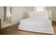Elegant bedroom with a plush white bed, stylish decor, and ample natural light, with access to a bathroom at 2538 Helmsman Rd, Johns Island, SC 29455