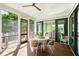 Relaxing screened-in patio boasts stylish seating and views of the lush backyard at 2538 Helmsman Rd, Johns Island, SC 29455