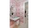 Powder room with red-and-white palm wallpaper, silver fixtures, and a door to the hallway at 2538 Helmsman Rd, Johns Island, SC 29455
