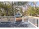 View from deck to backyard with a brick walkway leading to a detached structure, trees, and landscaping at 301 Beaufort St, Summerville, SC 29483