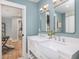 A stylish bathroom featuring double vanity sinks with square mirrors and modern lighting fixtures at 301 Beaufort St, Summerville, SC 29483