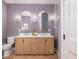 Elegant bathroom with dual vanities, arched mirrors, modern lighting, and walk-in shower with glass doors at 301 Beaufort St, Summerville, SC 29483