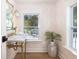 Charming powder room featuring palm wallpaper, brass fixtures, and natural light from two windows at 301 Beaufort St, Summerville, SC 29483