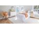 Charming bedroom with white furniture, wood floors, a stylish chair and ample natural light from multiple windows at 301 Beaufort St, Summerville, SC 29483