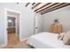 Bedroom with vaulted ceilings, wooden ceiling beams, and ensuite bath access, providing comfort and privacy at 301 Beaufort St, Summerville, SC 29483