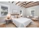 Cozy bedroom with neutral tones, wood floors, and ceiling beams creating a relaxing retreat at 301 Beaufort St, Summerville, SC 29483