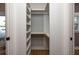 A tidy walk-in closet with built-in shelving, a hanging rod, and hardwood floors at 301 Beaufort St, Summerville, SC 29483