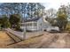 Quaint cottage with a metal roof, white picket fence, a lush front yard, and charming curb appeal at 301 Beaufort St, Summerville, SC 29483