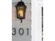 Close-up of the house number '301' with a decorative light fixture on the exterior wall at 301 Beaufort St, Summerville, SC 29483
