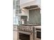 Updated kitchen features stainless steel appliances, herringbone backsplash, and custom white cabinetry at 301 Beaufort St, Summerville, SC 29483