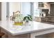 Kitchen island boasts a white countertop, complementing the white cabinets and stainless steel appliances at 301 Beaufort St, Summerville, SC 29483