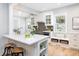 Modern kitchen with white cabinetry, herringbone backsplash, quartz countertops, and stainless appliances at 301 Beaufort St, Summerville, SC 29483