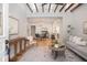 Open concept living room features a decorative rug, light gray sofa, and exposed beam ceiling at 301 Beaufort St, Summerville, SC 29483