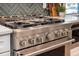 Close-up of the stainless steel range oven with herringbone backsplash, offering professional-grade cooking at 301 Beaufort St, Summerville, SC 29483