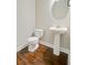 Neat half bathroom featuring a pedestal sink, a round mirror, and a standard toilet at 330 Albrighton Way, Moncks Corner, SC 29461
