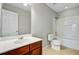 Bathroom with white cabinets, dark brown vanity, recessed lighting, and combined shower and bathtub at 330 Albrighton Way, Moncks Corner, SC 29461