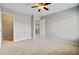 Empty bedroom with carpet, fan, and two entryways; one leads to a closet with shelving at 330 Albrighton Way, Moncks Corner, SC 29461