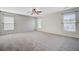 A bright, carpeted bedroom featuring three windows for plenty of natural light and fresh air at 330 Albrighton Way, Moncks Corner, SC 29461