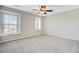 Bright, open bedroom with neutral carpet, ceiling fan, and natural light from large windows at 330 Albrighton Way, Moncks Corner, SC 29461